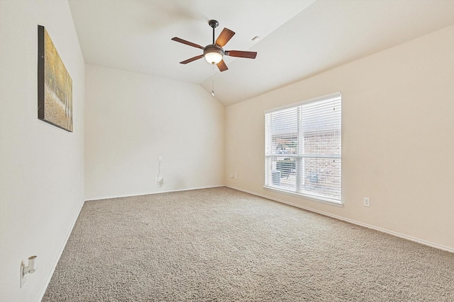 carpeted empty room with vaulted ceiling and ceiling fan