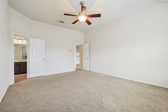 unfurnished bedroom featuring ceiling fan, connected bathroom, and light colored carpet