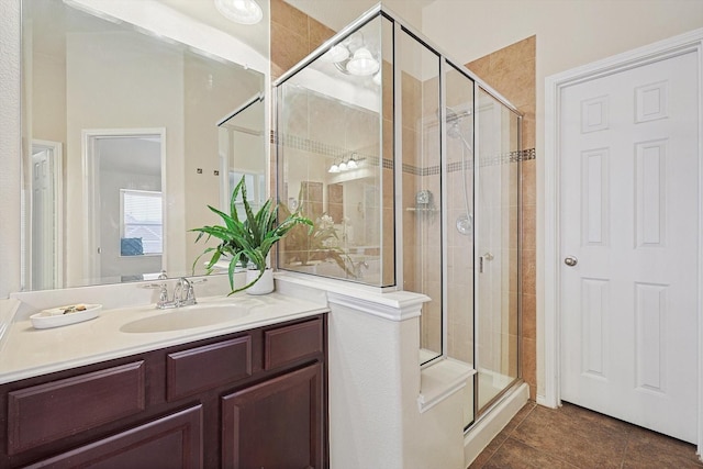 bathroom with tile patterned floors, vanity, and a shower with door