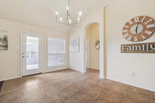 unfurnished dining area featuring tile patterned floors, lofted ceiling, and a notable chandelier