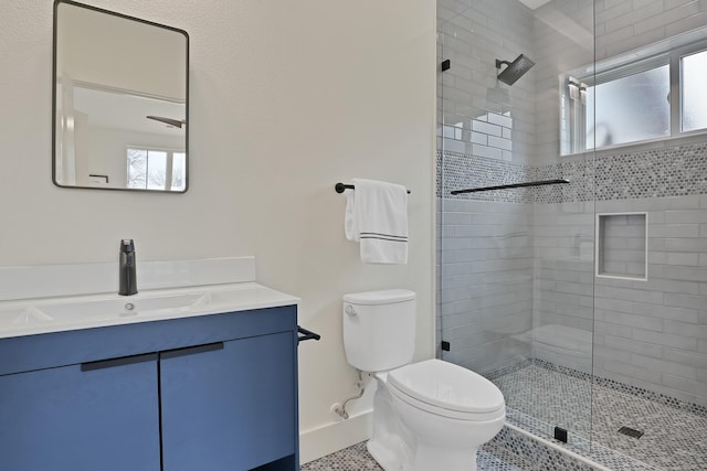 bathroom with tile patterned floors, vanity, toilet, and a shower with door