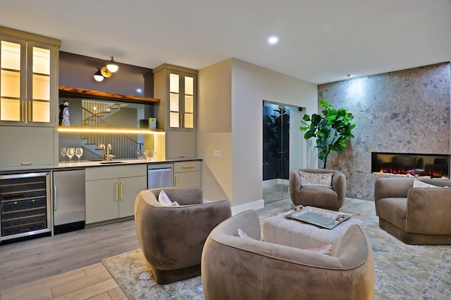 interior space featuring sink, beverage cooler, stainless steel refrigerator, and a fireplace