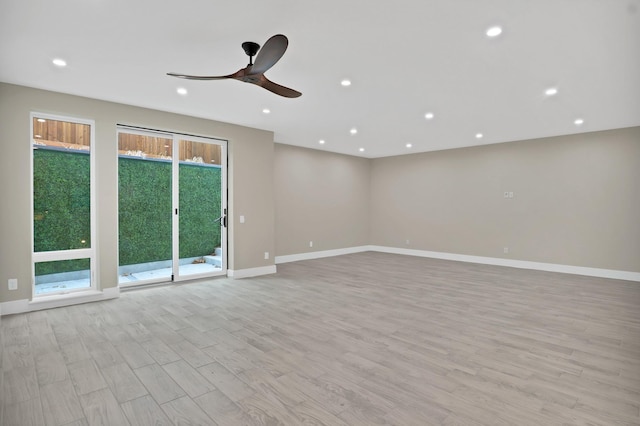 spare room with ceiling fan and light wood-type flooring