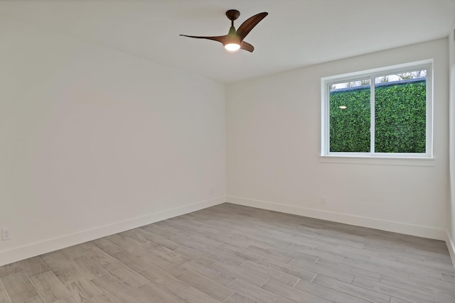 empty room featuring ceiling fan and light wood-type flooring