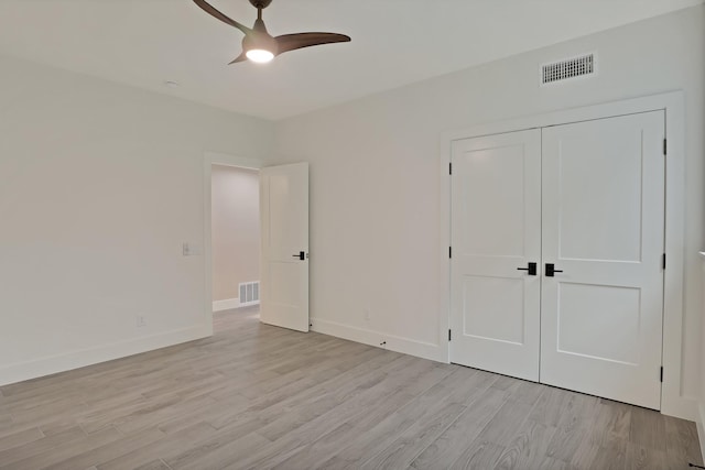 unfurnished bedroom with a closet, ceiling fan, and light wood-type flooring