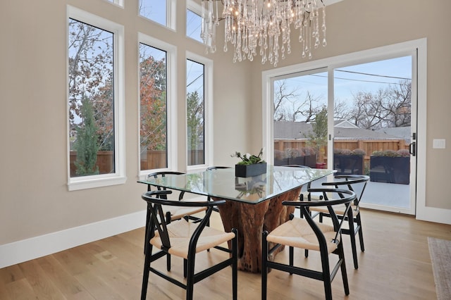 dining space featuring a notable chandelier and light hardwood / wood-style floors