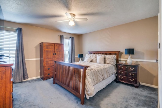 carpeted bedroom with ceiling fan and a textured ceiling