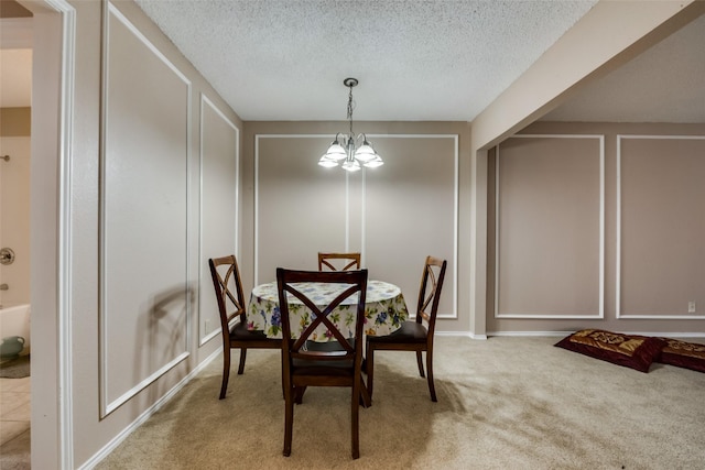 dining space featuring an inviting chandelier and carpet