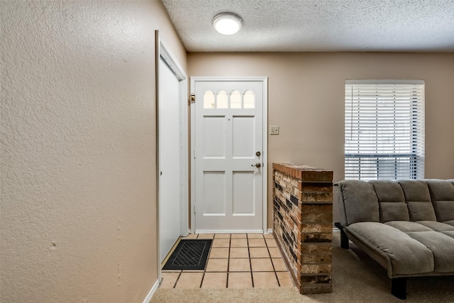 tiled foyer entrance featuring a textured ceiling