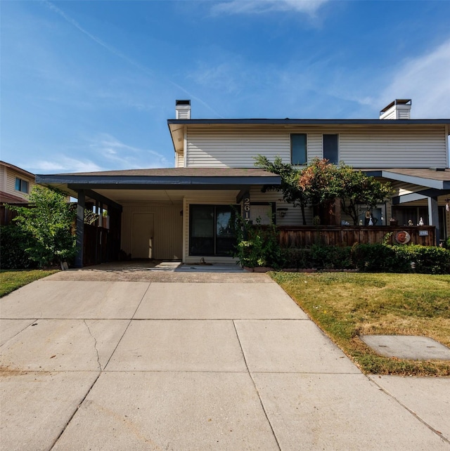 view of front of property featuring a carport and a front lawn