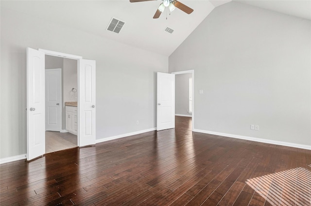 spare room featuring dark hardwood / wood-style flooring, high vaulted ceiling, and ceiling fan