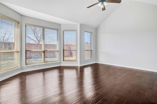 unfurnished room with dark hardwood / wood-style flooring, plenty of natural light, and lofted ceiling