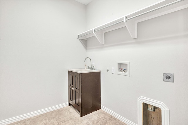 washroom featuring sink, light tile patterned floors, washer hookup, hookup for an electric dryer, and hookup for a gas dryer