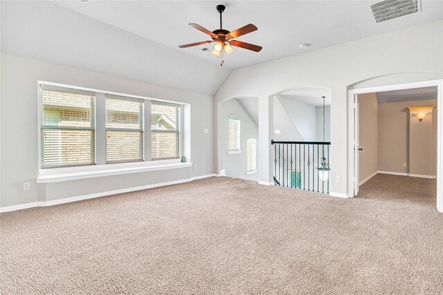 carpeted empty room featuring lofted ceiling and ceiling fan