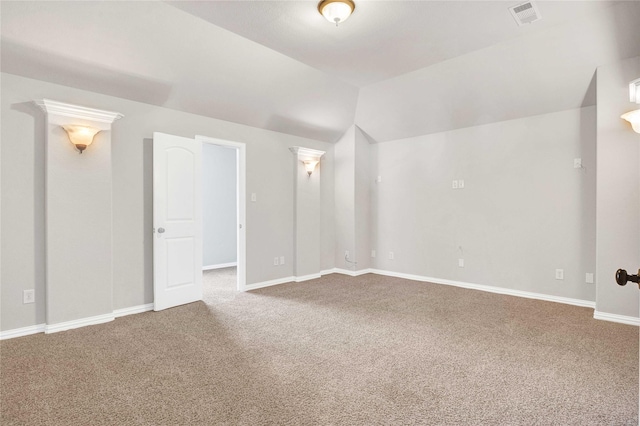 additional living space featuring lofted ceiling and carpet