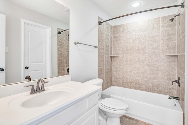 full bathroom with vanity, toilet, and tiled shower / bath combo