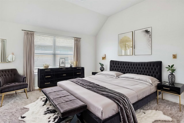 carpeted bedroom featuring lofted ceiling