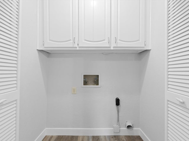 laundry room featuring cabinets, washer hookup, hookup for an electric dryer, and hardwood / wood-style floors