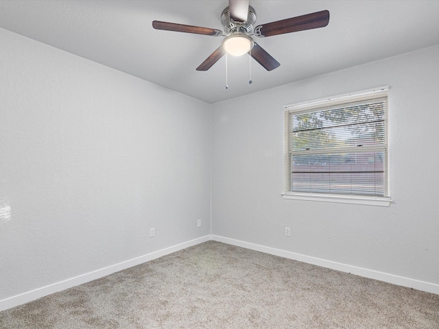 empty room with ceiling fan and carpet