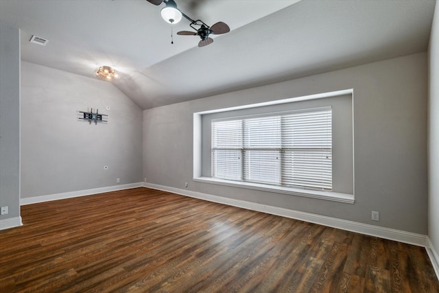 unfurnished room featuring lofted ceiling, dark wood-type flooring, and ceiling fan