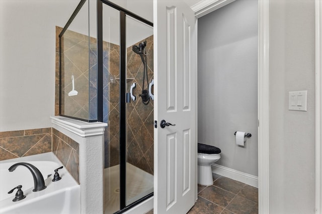 bathroom featuring toilet and separate shower and tub