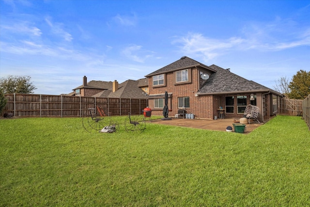 rear view of property with a yard and a patio area