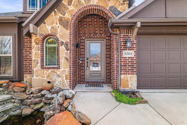 view of exterior entry with a garage