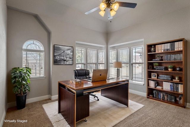 carpeted office featuring lofted ceiling, a healthy amount of sunlight, and ceiling fan