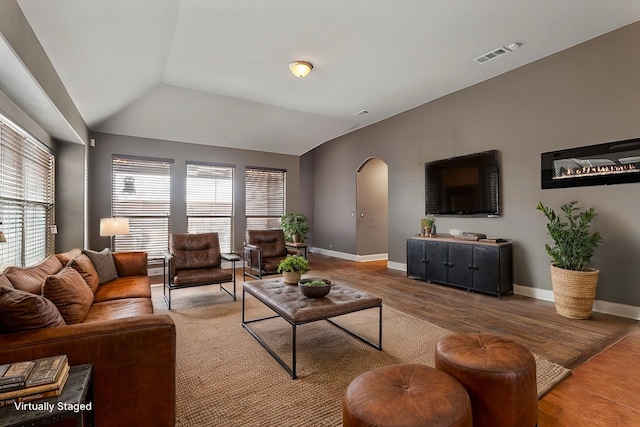 living room with hardwood / wood-style floors and vaulted ceiling