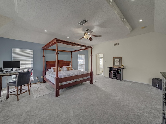 bedroom featuring light carpet, ceiling fan, vaulted ceiling, and a textured ceiling