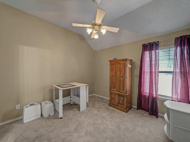 miscellaneous room featuring vaulted ceiling, light colored carpet, ceiling fan, and a textured ceiling