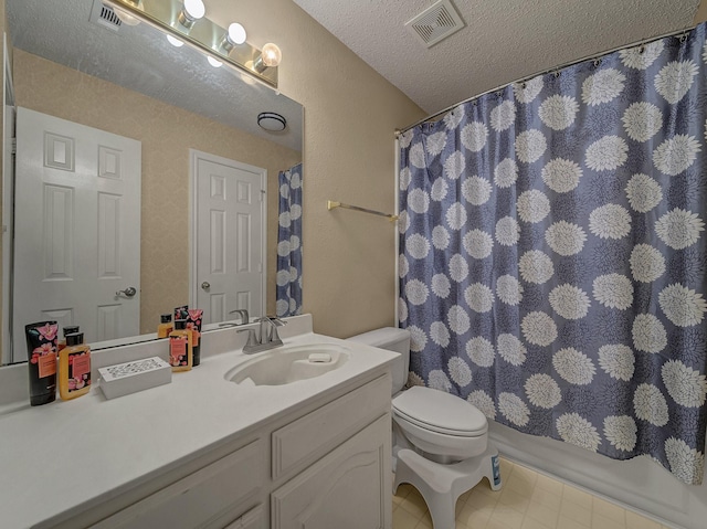 bathroom with vanity, a textured ceiling, and toilet