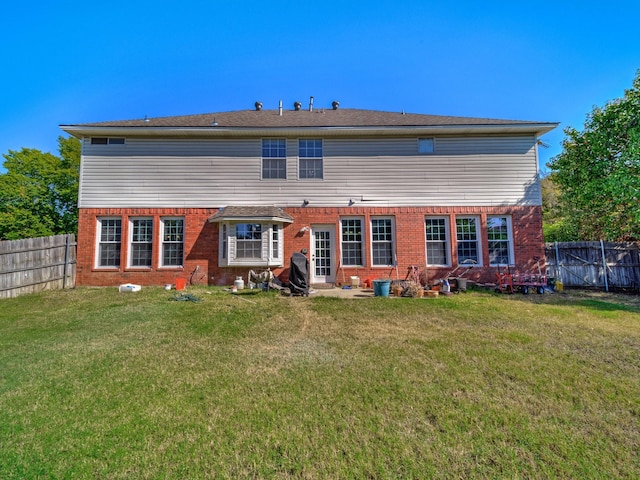 rear view of property featuring a yard