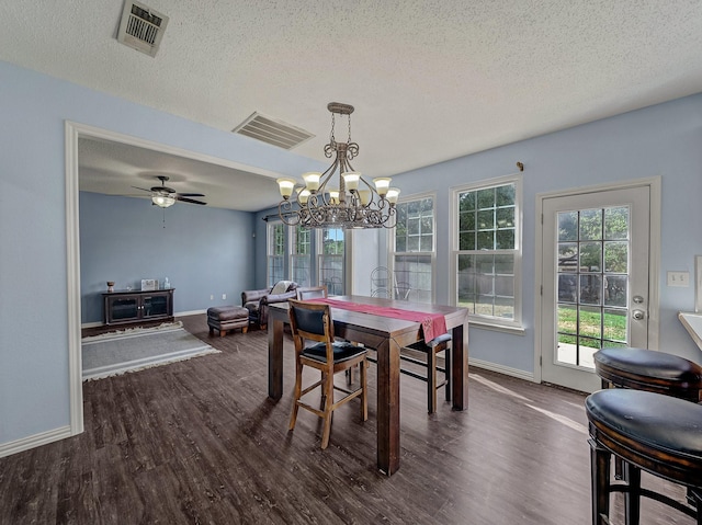 dining space with ceiling fan, dark wood-type flooring, and a textured ceiling