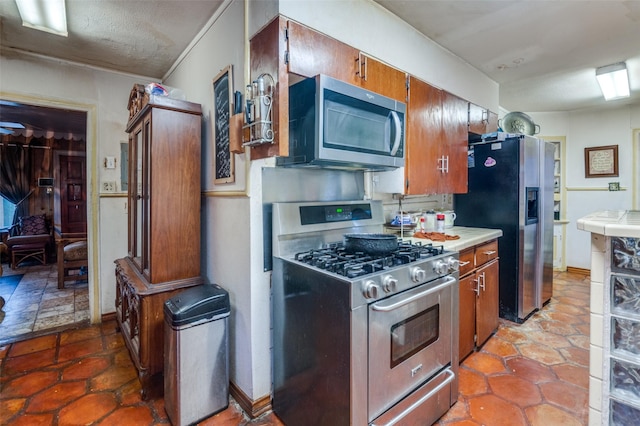 kitchen with stainless steel appliances and a textured ceiling