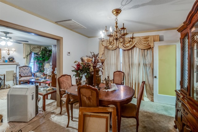 dining room featuring ornamental molding, a notable chandelier, and a fireplace