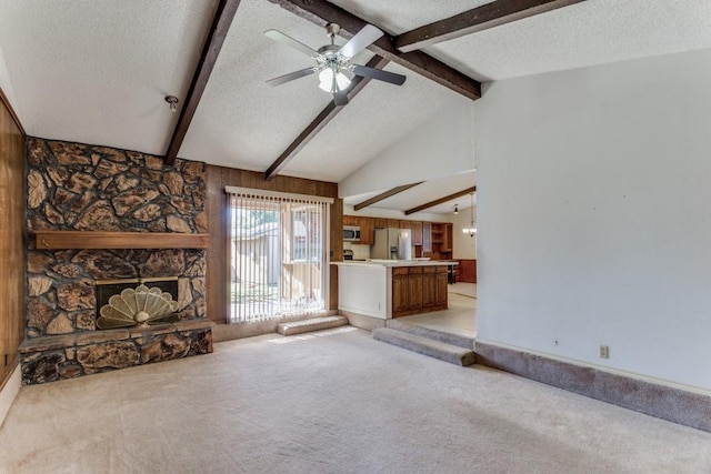 unfurnished living room featuring ceiling fan, lofted ceiling with beams, light colored carpet, and a textured ceiling