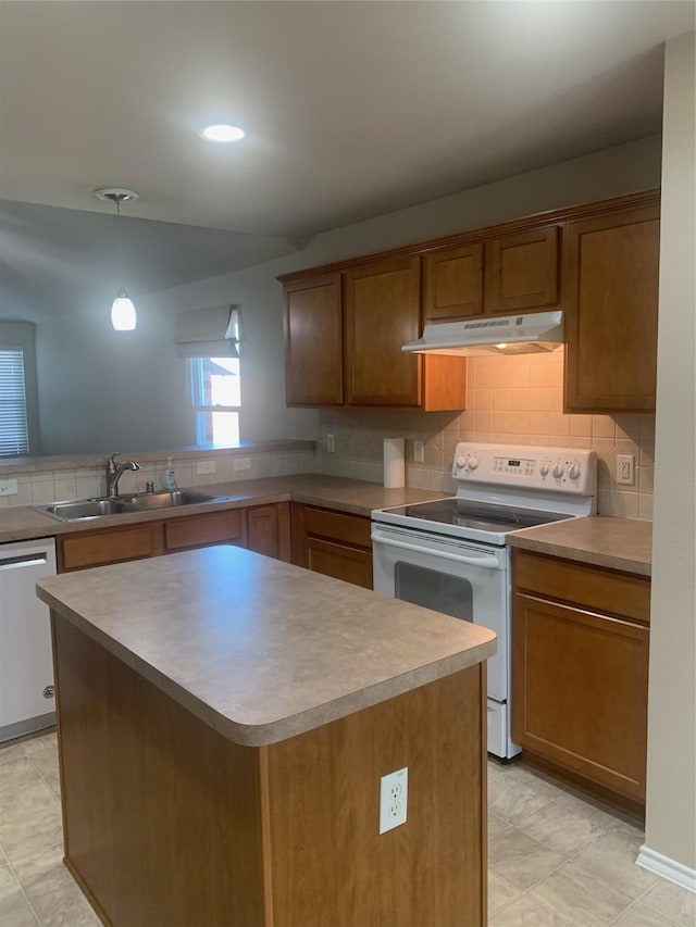 kitchen featuring sink, white appliances, a center island, tasteful backsplash, and decorative light fixtures