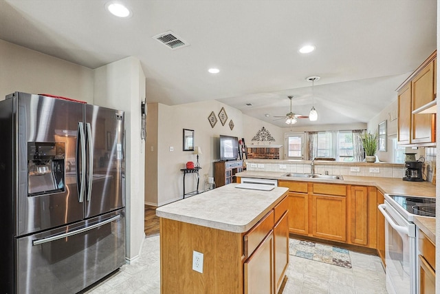 kitchen with stainless steel refrigerator with ice dispenser, lofted ceiling, sink, white electric stove, and a kitchen island