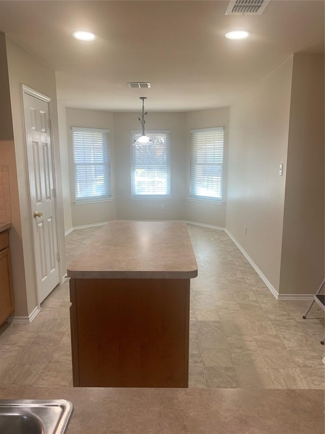 kitchen with decorative light fixtures and a center island