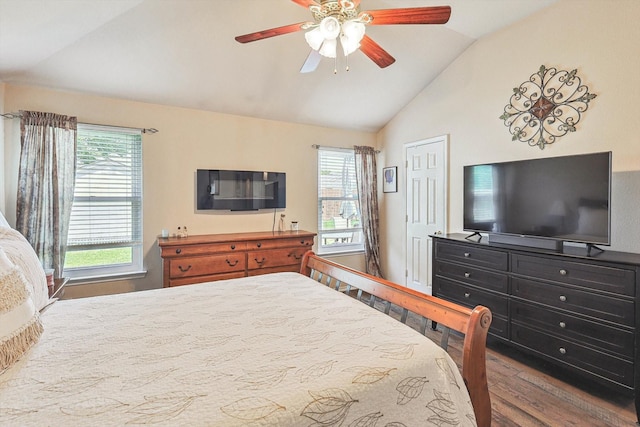 bedroom featuring lofted ceiling, hardwood / wood-style floors, multiple windows, and ceiling fan