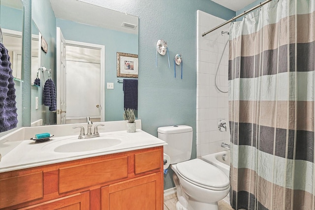 full bathroom with vanity, shower / bath combo with shower curtain, and toilet