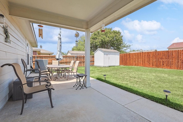 view of patio featuring cooling unit and a shed