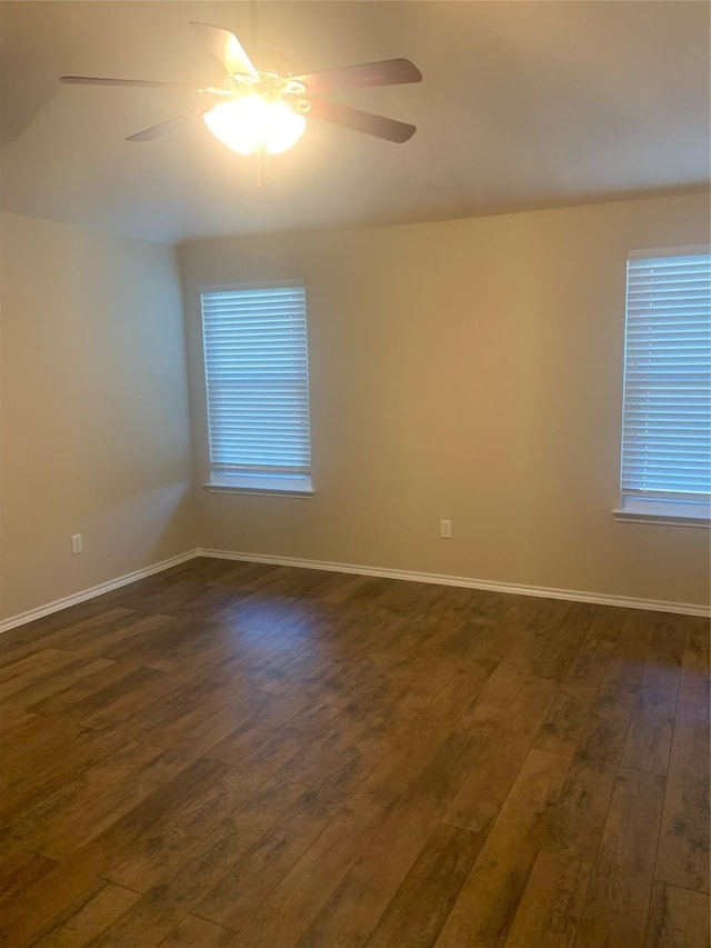 unfurnished room with ceiling fan and dark hardwood / wood-style flooring