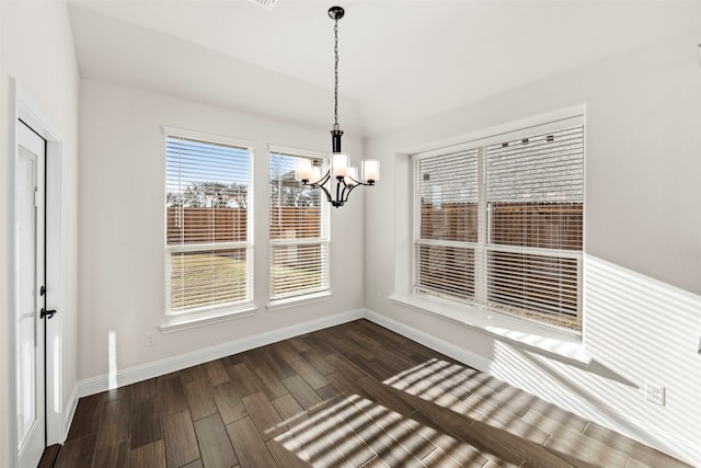 unfurnished dining area with an inviting chandelier