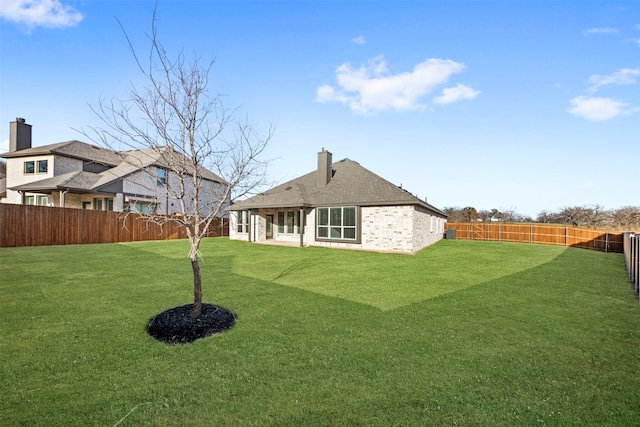 rear view of property with a yard