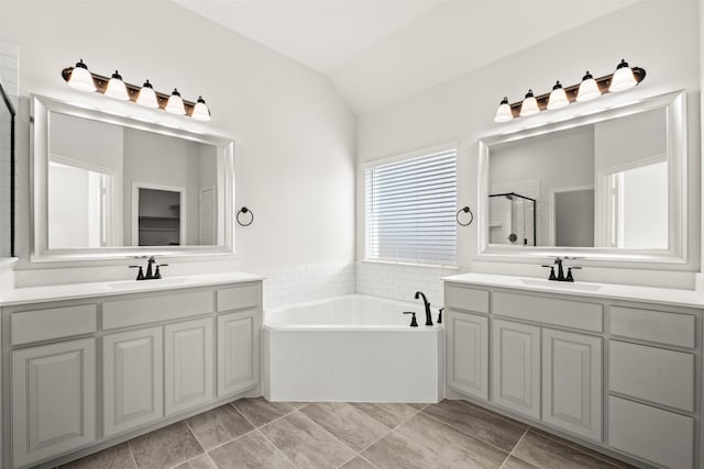 bathroom featuring tile patterned flooring, shower with separate bathtub, lofted ceiling, and vanity