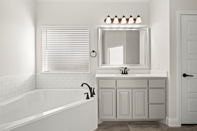 bathroom with vanity, a tub to relax in, and tile patterned flooring