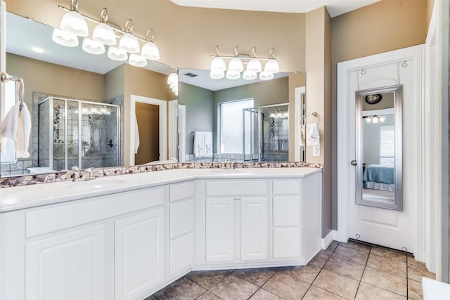 bathroom with tile patterned flooring, vanity, and a shower with shower door