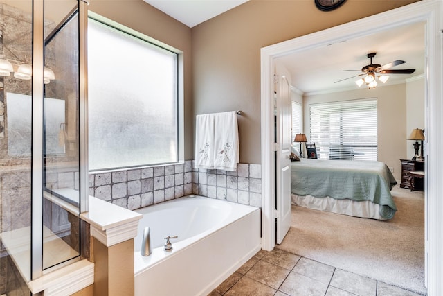 bathroom featuring a washtub, crown molding, tile patterned floors, and ceiling fan